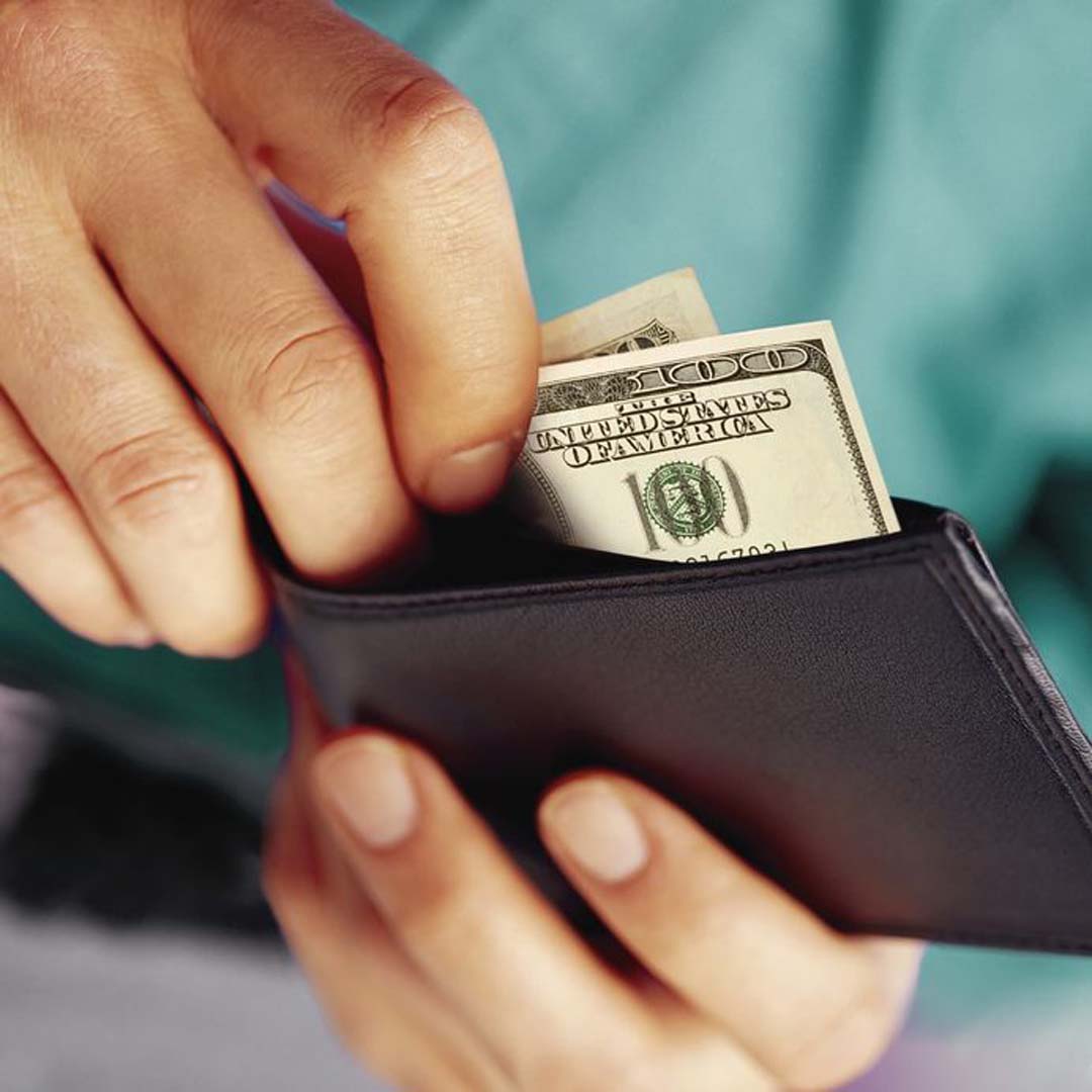Person pulling money out of a wallet
